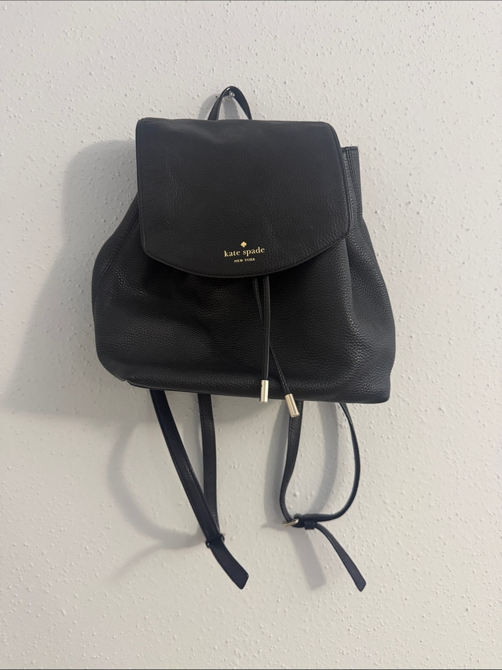 kate spade Black Pebbled Leather Flap Drawstring Backpack with Gold Hardware